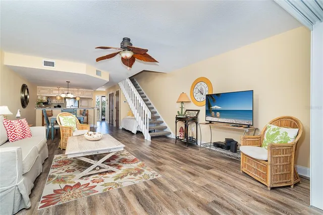 a living room with furniture and a chandelier