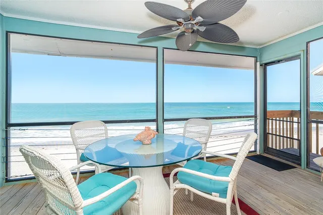 a view of a dining room with a table and chairs