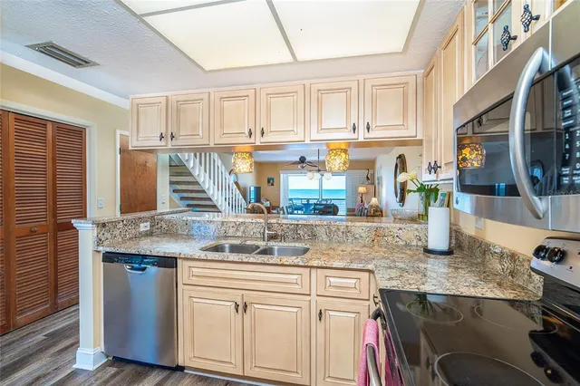 a kitchen with stainless steel appliances granite countertop a sink and cabinets