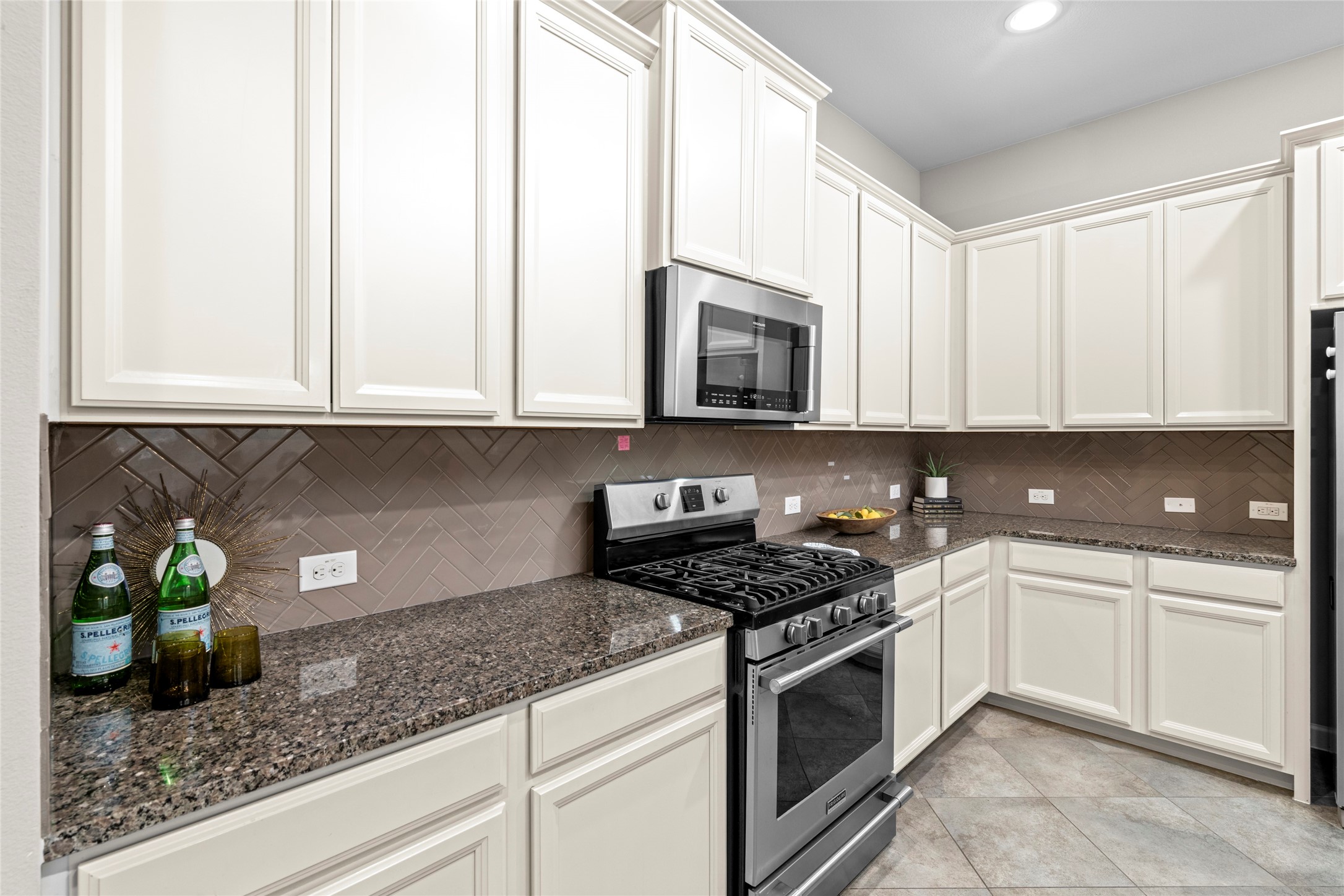 143 Castlegate Lane Houston, TX 77065 - Photo 18 of 33 The herringbone pattern of the tile adds an elegant touch. Kitchen faucet (2026). Garbage disposal (2026). Water filtration system (2020)