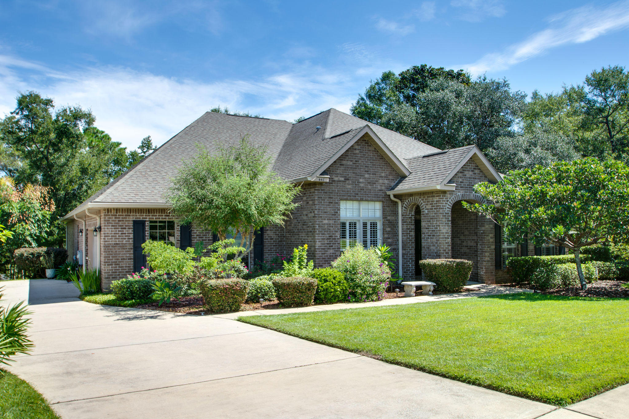 446 Mango Lane Freeport, FL 32439 - Photo 2 of 48 a front view of a house with a garden and plants
