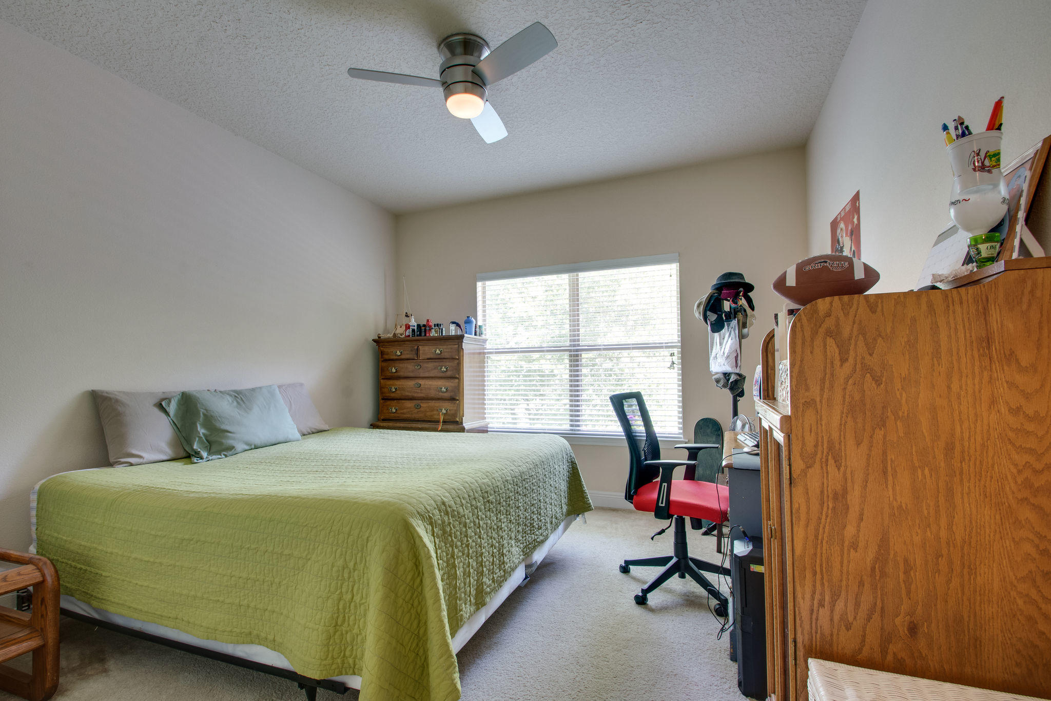 446 Mango Lane Freeport, FL 32439 - Photo 24 of 48 a bedroom with a bed and a chandelier