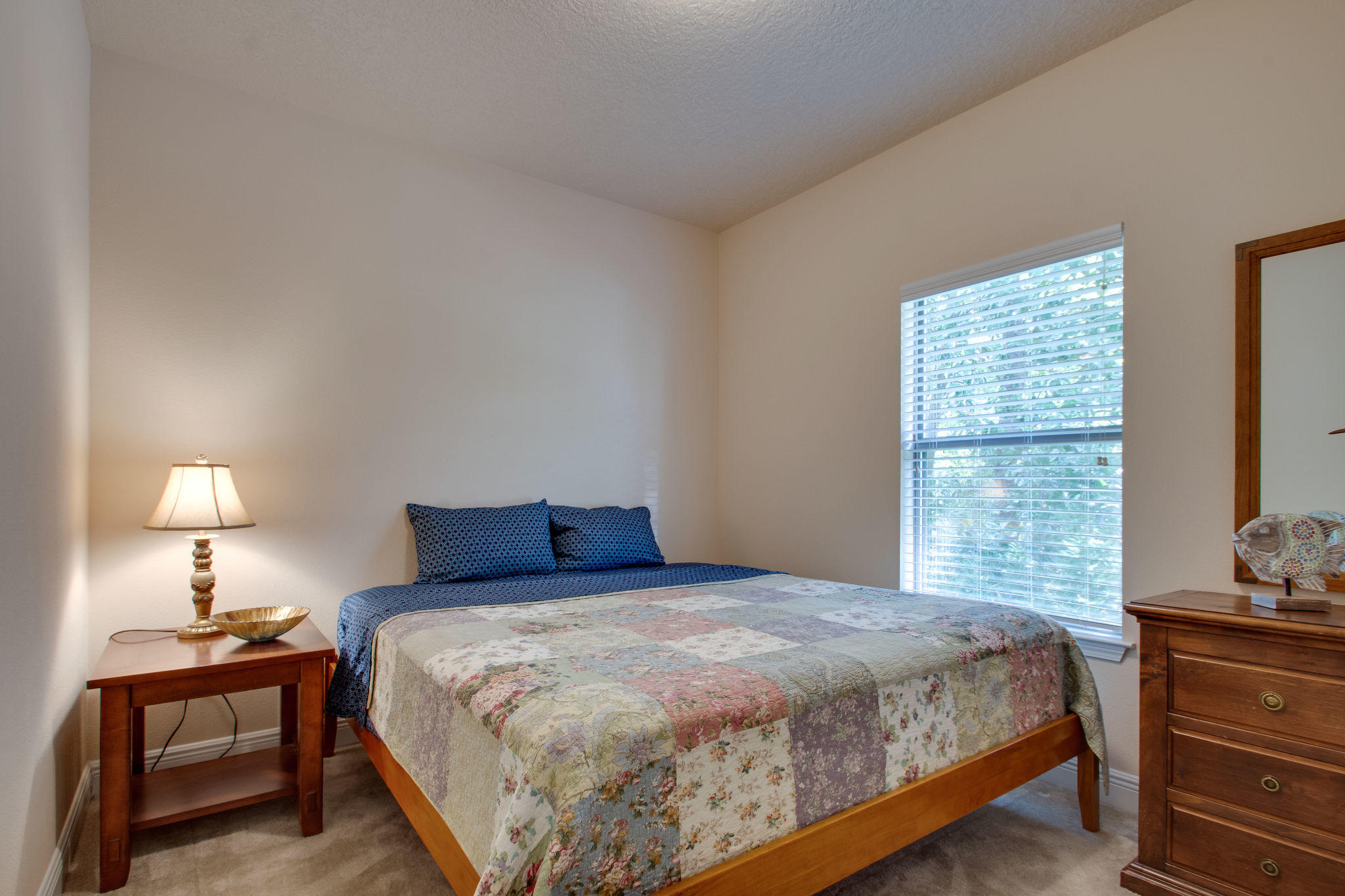 446 Mango Lane Freeport, FL 32439 - Photo 27 of 48 a bedroom with a bed and a lamp on dresser