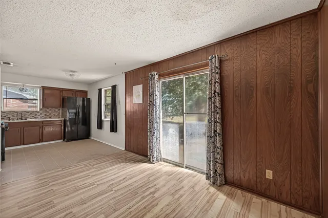 a big room with wooden floor and windows