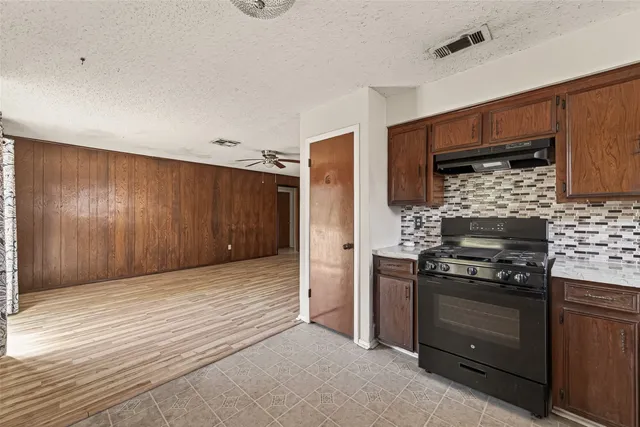 a kitchen with a stove and a refrigerator