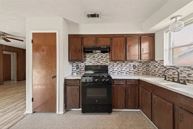 a kitchen with a sink and cabinets