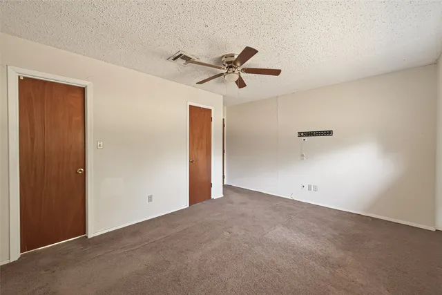 a view of room with a ceiling fan