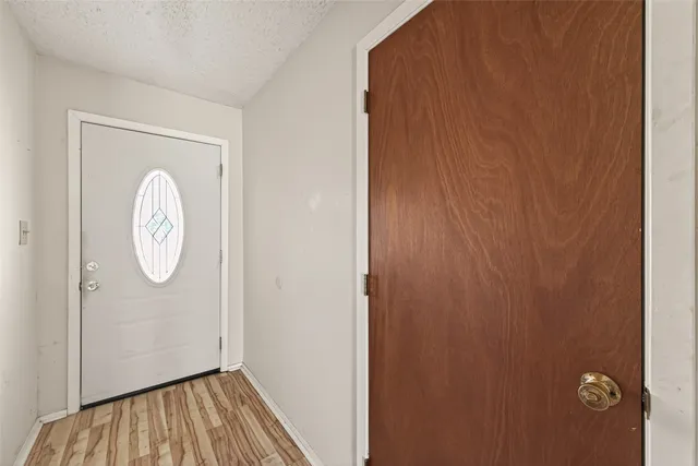 a view of a room with wooden floor