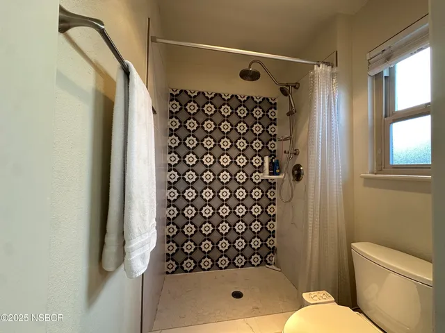 a bathroom with a bathtub and shower