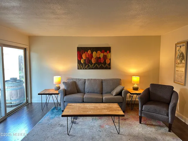 a living room with furniture and a potted plant