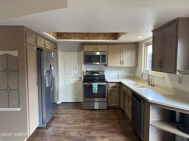 a kitchen with a sink and a stove top oven
