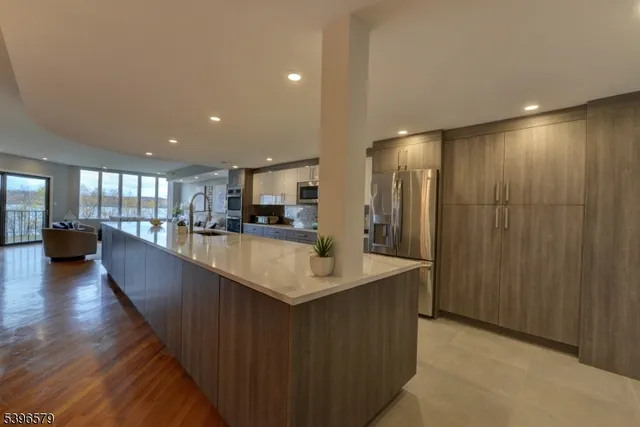 a large kitchen with stainless steel appliances a large counter top