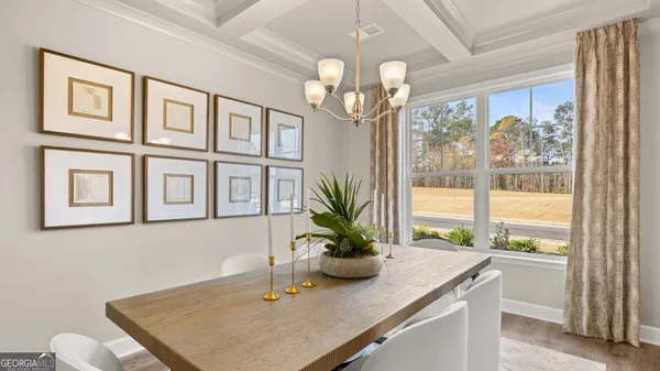 a kitchen with stainless steel appliances kitchen island granite countertop a stove a sink and white cabinets with wooden floor
