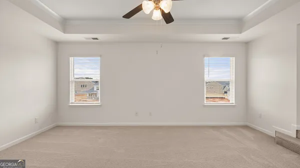 a view of an empty room with a fireplace and a window