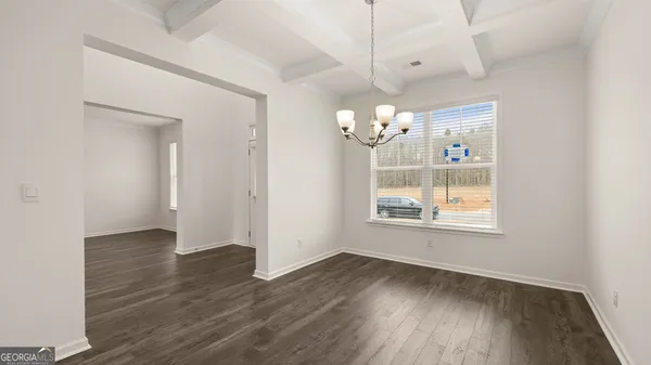 a dining room with furniture and chandelier