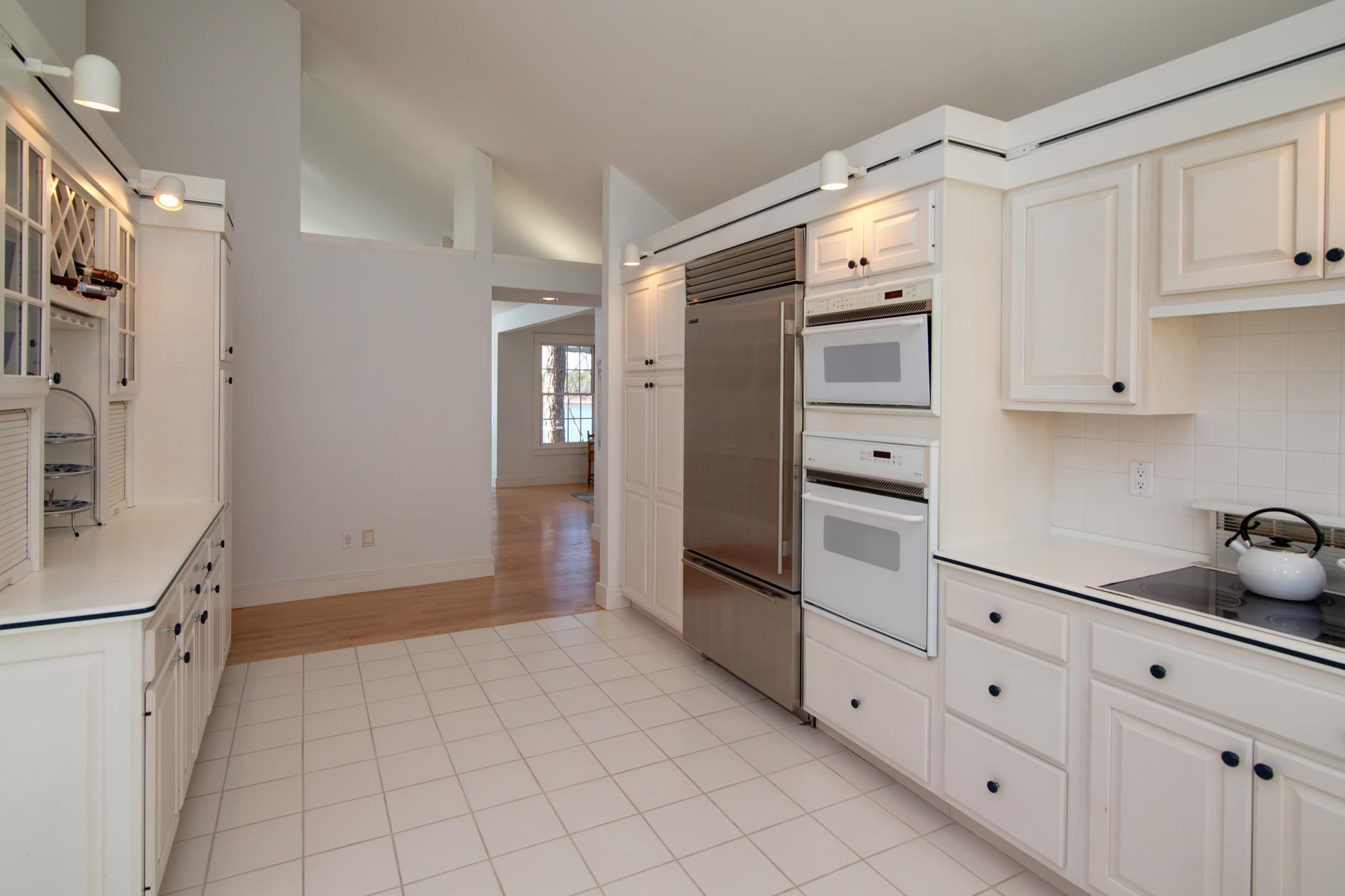 624 Poponessett Road Cotuit, MA 02635 - Photo 15 of 30 a kitchen with white cabinets and refrigerator