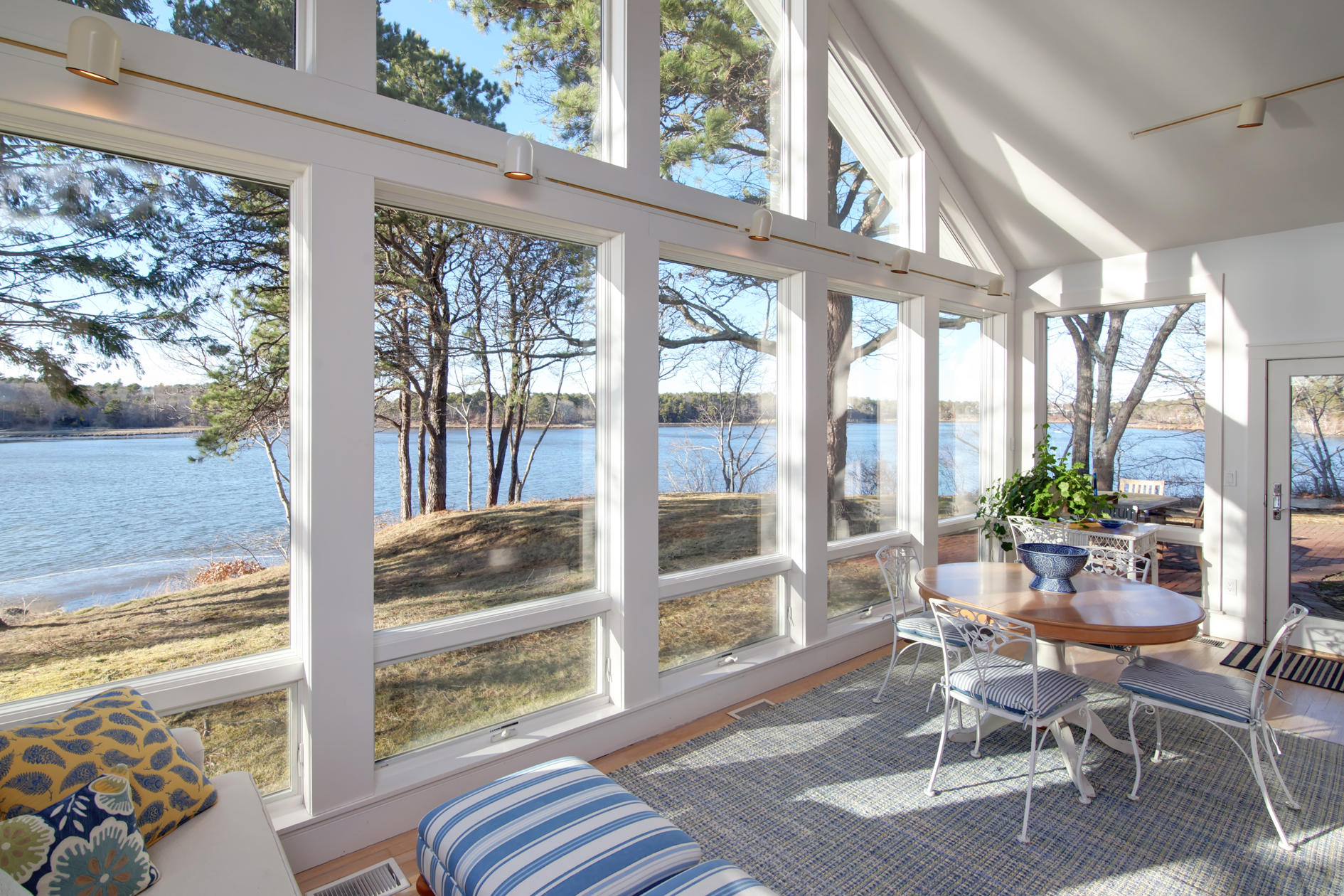 624 Poponessett Road Cotuit, MA 02635 - Photo 7 of 30 a living room with large windows