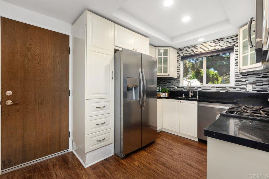 4369 Dowitcher Way Oceanside, CA 92057 - Photo 11 of 37 a kitchen with a refrigerator and a sink