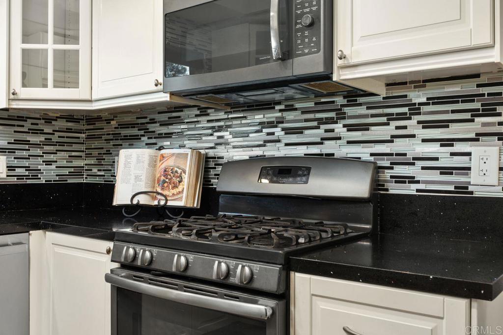 4369 Dowitcher Way Oceanside, CA 92057 - Photo 13 of 37 a kitchen with a stove and a microwave