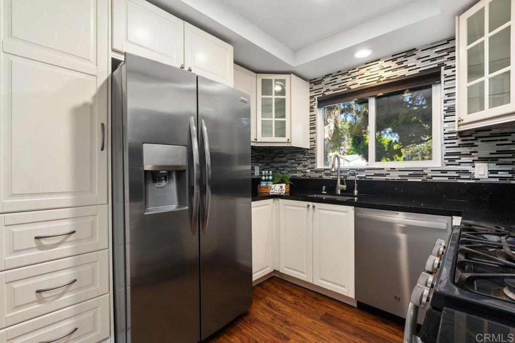 4369 Dowitcher Way Oceanside, CA 92057 - Photo 15 of 37 a kitchen with stainless steel appliances granite countertop a refrigerator and a sink