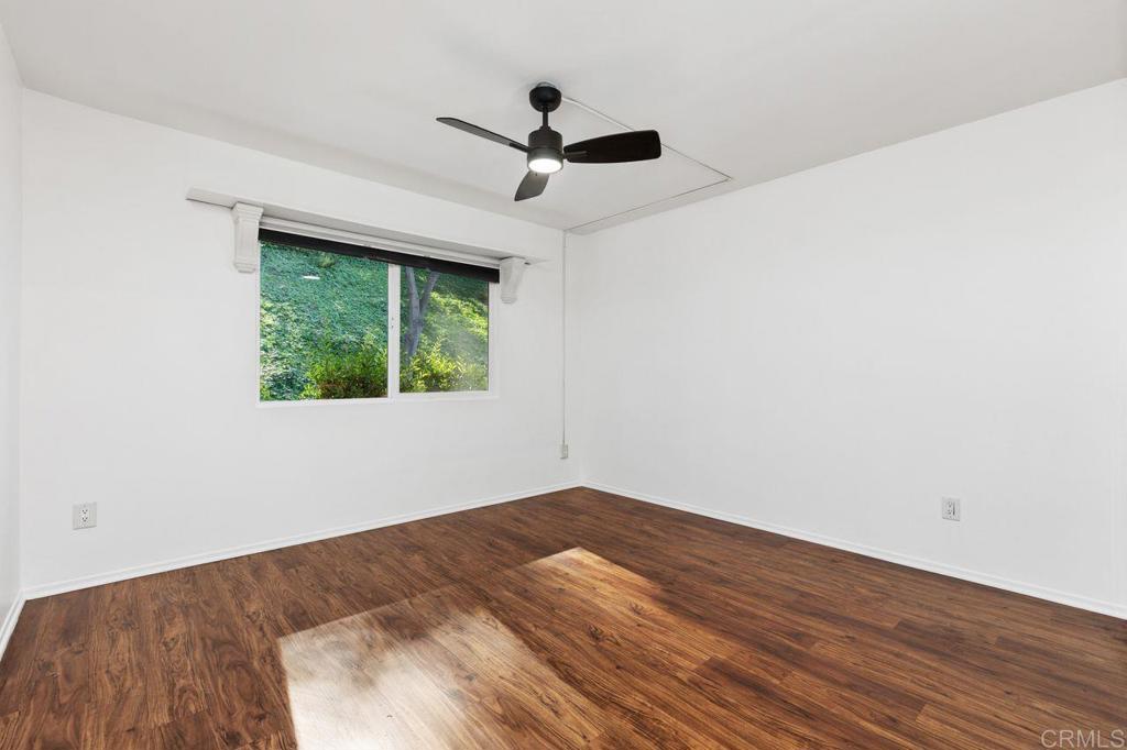 4369 Dowitcher Way Oceanside, CA 92057 - Photo 17 of 37 a view of empty room with wooden floor and fan