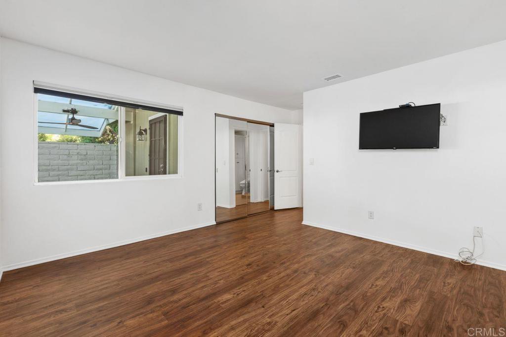4369 Dowitcher Way Oceanside, CA 92057 - Photo 20 of 37 a view of an empty room with wooden floor and a window