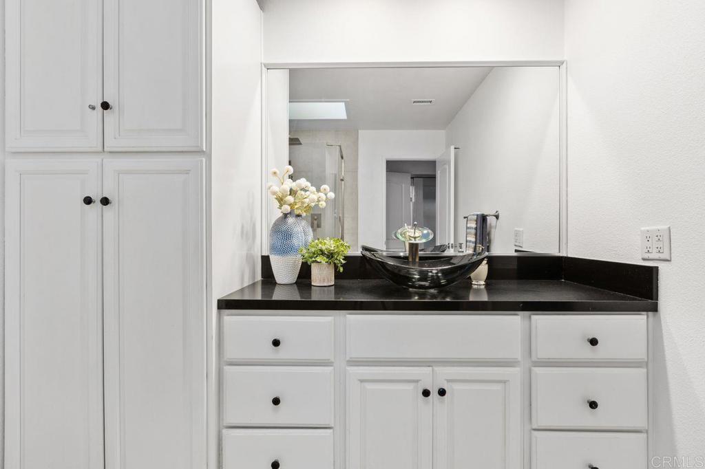 4369 Dowitcher Way Oceanside, CA 92057 - Photo 25 of 37 a bathroom with a granite countertop sink and a mirror