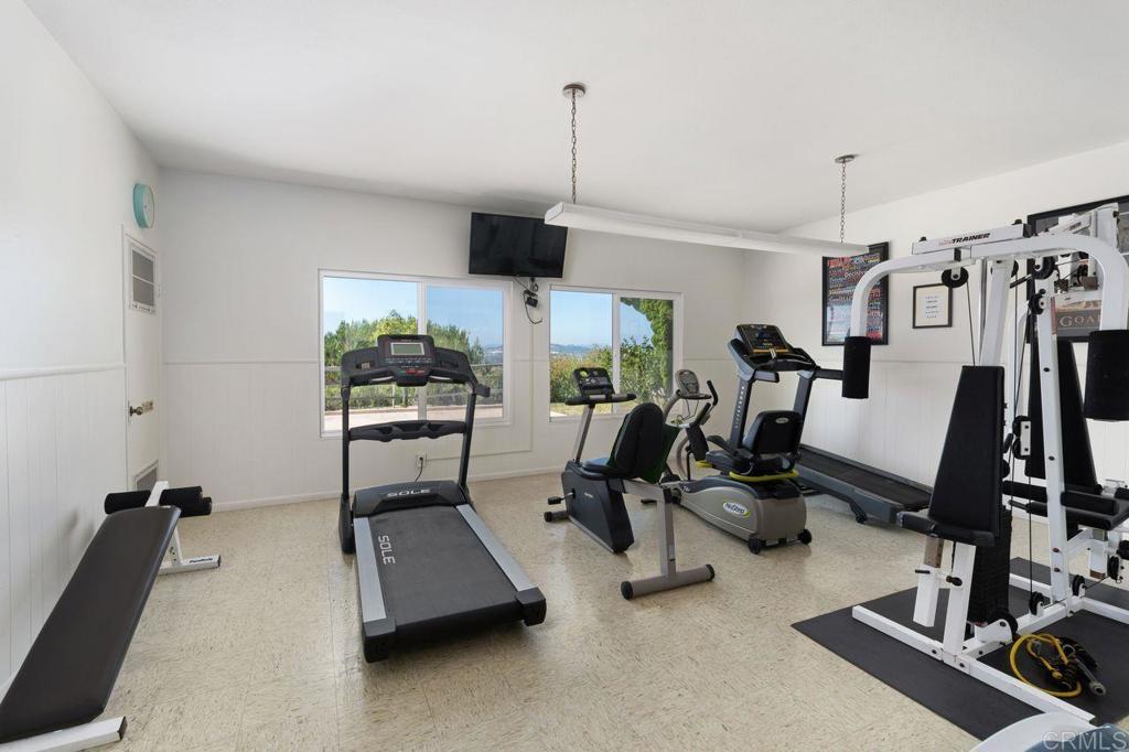 4369 Dowitcher Way Oceanside, CA 92057 - Photo 33 of 37 a room with gym equipment and a flat screen tv