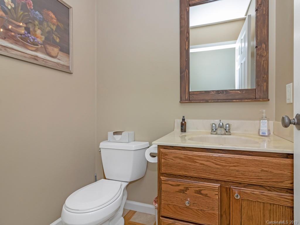 315 Garren Creek Road Rosman, NC 28772 - Photo 12 of 36 a bathroom with a granite countertop toilet sink and mirror