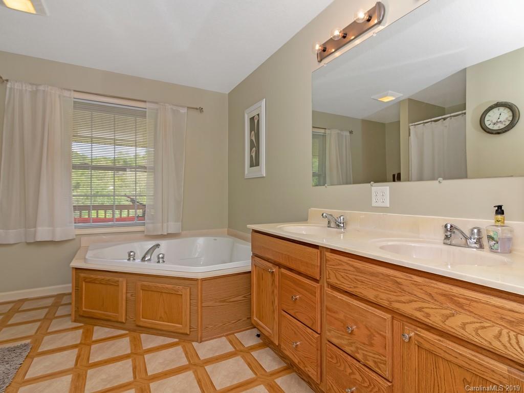 315 Garren Creek Road Rosman, NC 28772 - Photo 14 of 36 a spacious bathroom with a sink mirror and a bathtub