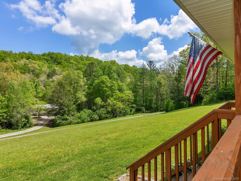 315 Garren Creek Road Rosman, NC 28772 - Photo 34 of 36 a view of a lush green space next to a yard