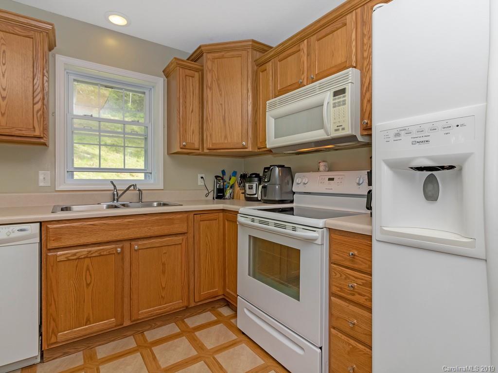 315 Garren Creek Road Rosman, NC 28772 - Photo 7 of 36 a kitchen with stainless steel appliances granite countertop a sink and a microwave