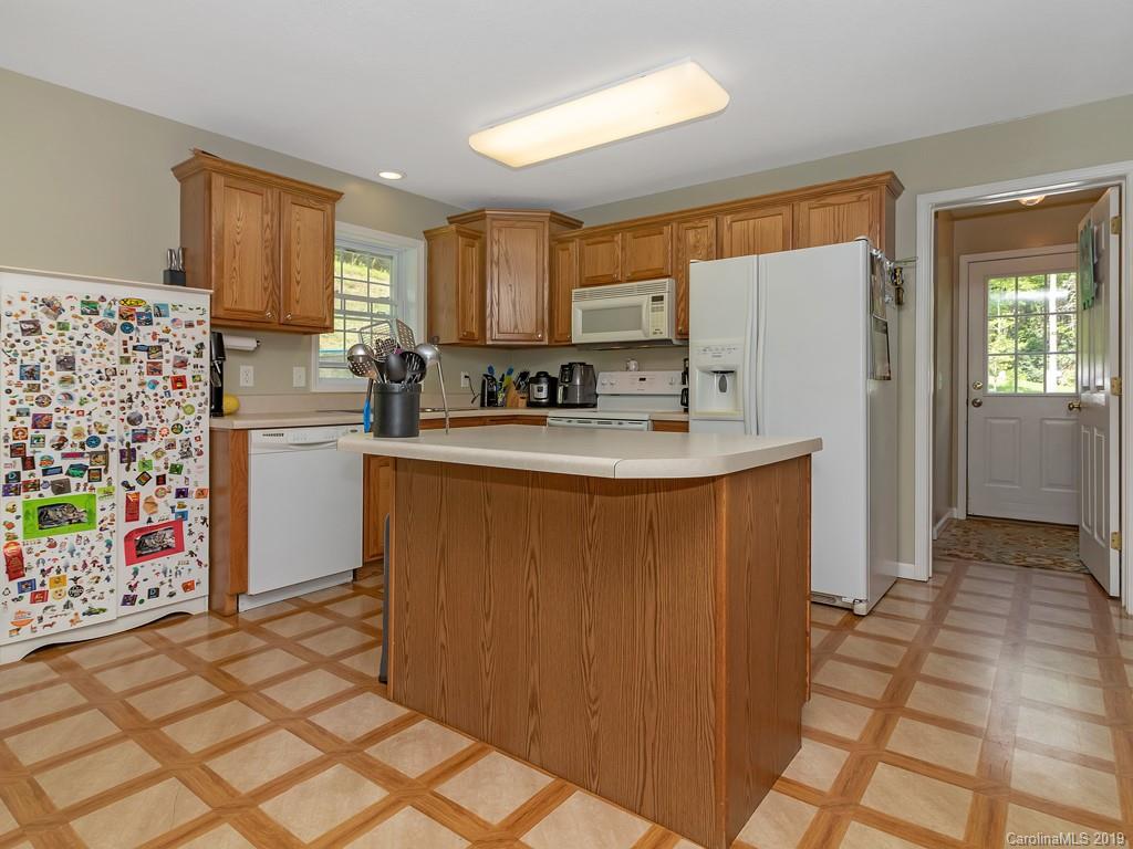 315 Garren Creek Road Rosman, NC 28772 - Photo 8 of 36 a kitchen with stainless steel appliances granite countertop a refrigerator and a stove