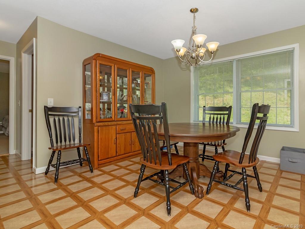 315 Garren Creek Road Rosman, NC 28772 - Photo 9 of 36 a view of a dining room with furniture and a chandelier