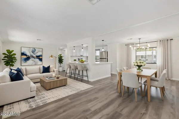 a living room with furniture and wooden floor