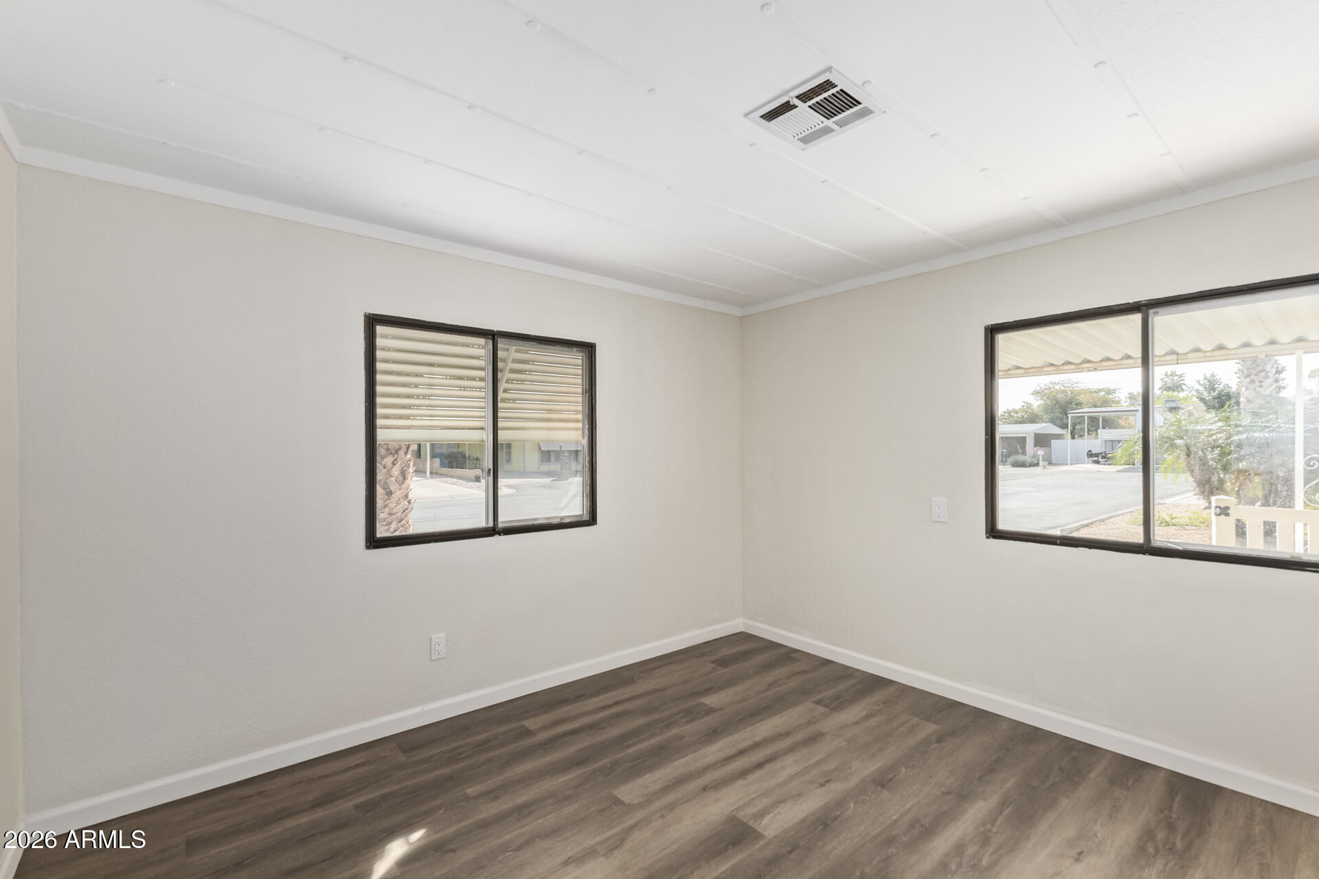 16216 North 35th Way Phoenix, AZ 85032 - Photo 13 of 17 an empty room with wooden floor and windows