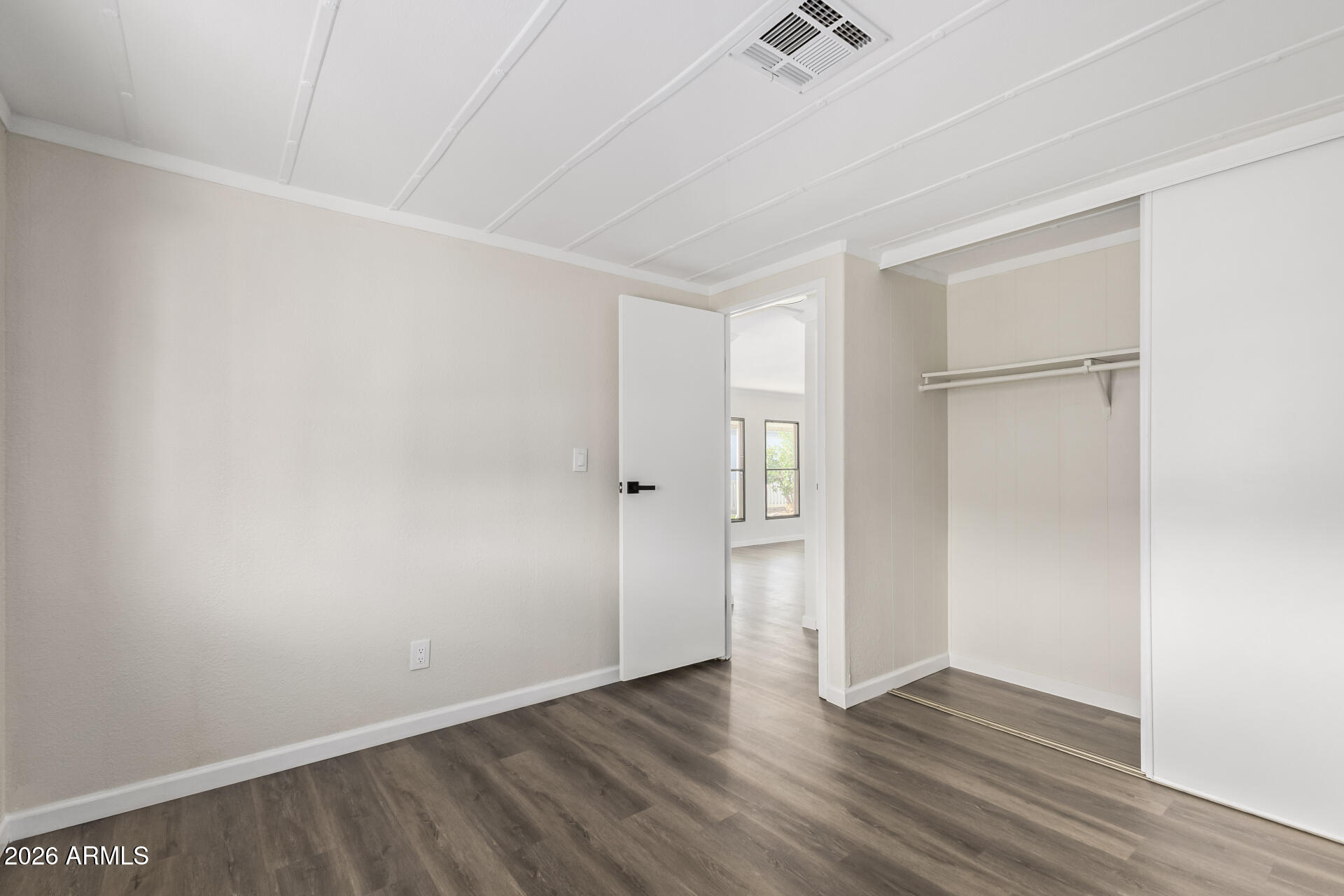 16216 North 35th Way Phoenix, AZ 85032 - Photo 14 of 17 a view of an empty room with wooden floor