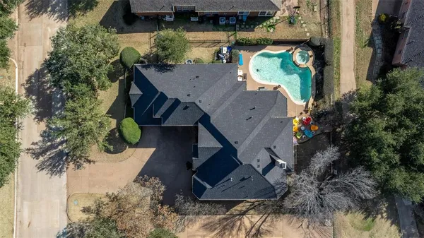 an aerial view of a house with a yard