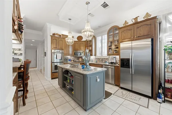 a kitchen with stainless steel appliances granite countertop a stove and a refrigerator