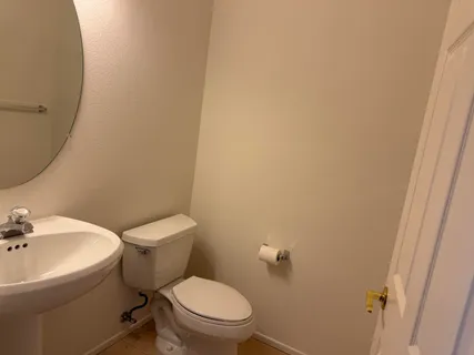 a white toilet sitting next to a white sink