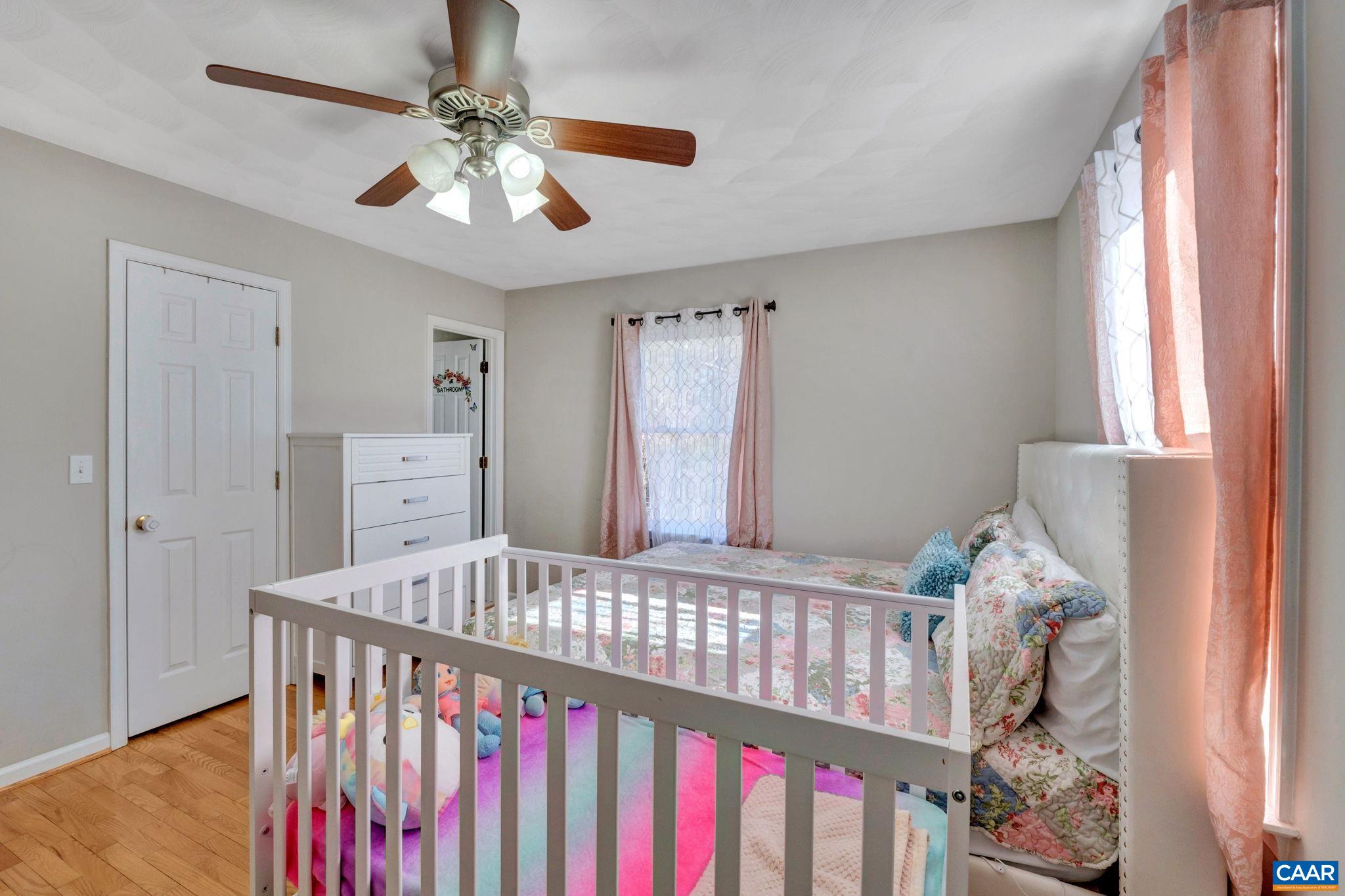 47 Dandelion Road Ruckersville, VA 22968 - Photo 13 of 35 a bedroom with a bed and a chandelier
