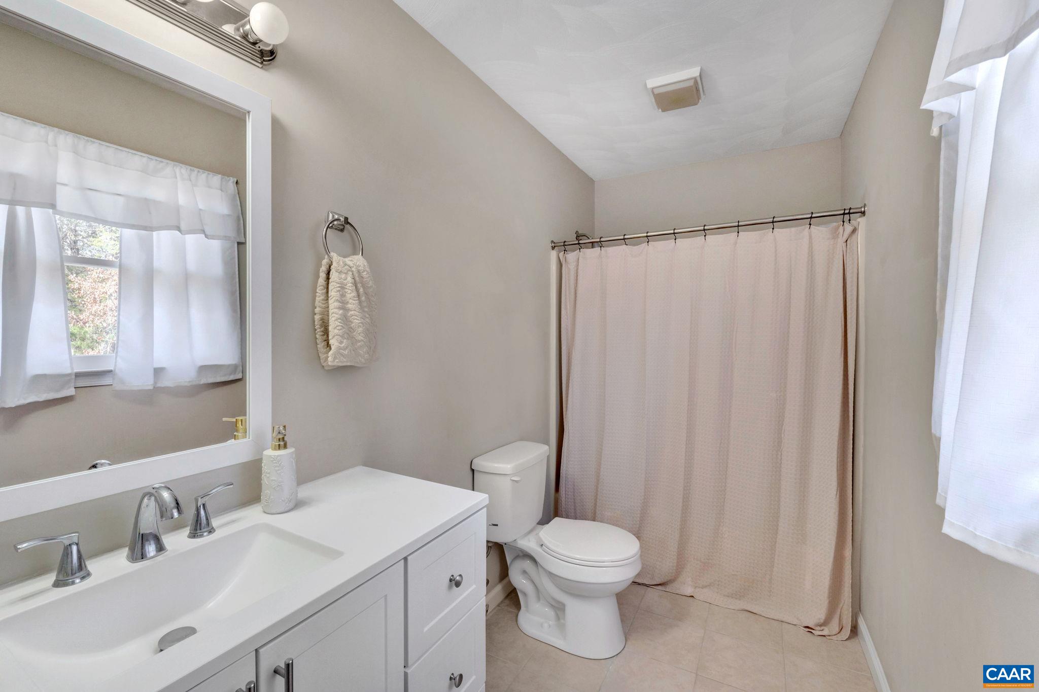 47 Dandelion Road Ruckersville, VA 22968 - Photo 14 of 35 a bathroom with a toilet a sink and a mirror