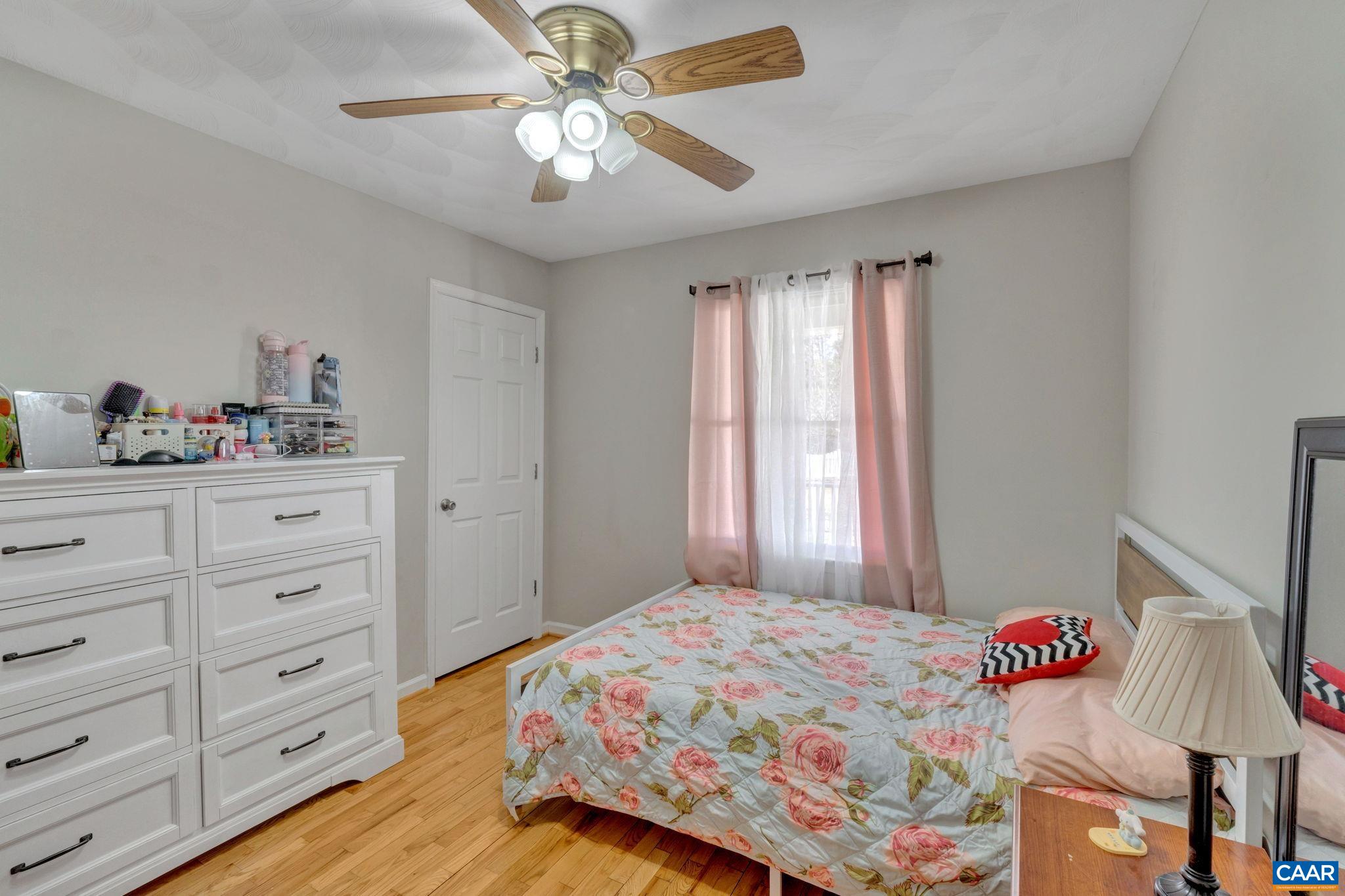 47 Dandelion Road Ruckersville, VA 22968 - Photo 15 of 35 a bedroom with a bed and a chandelier