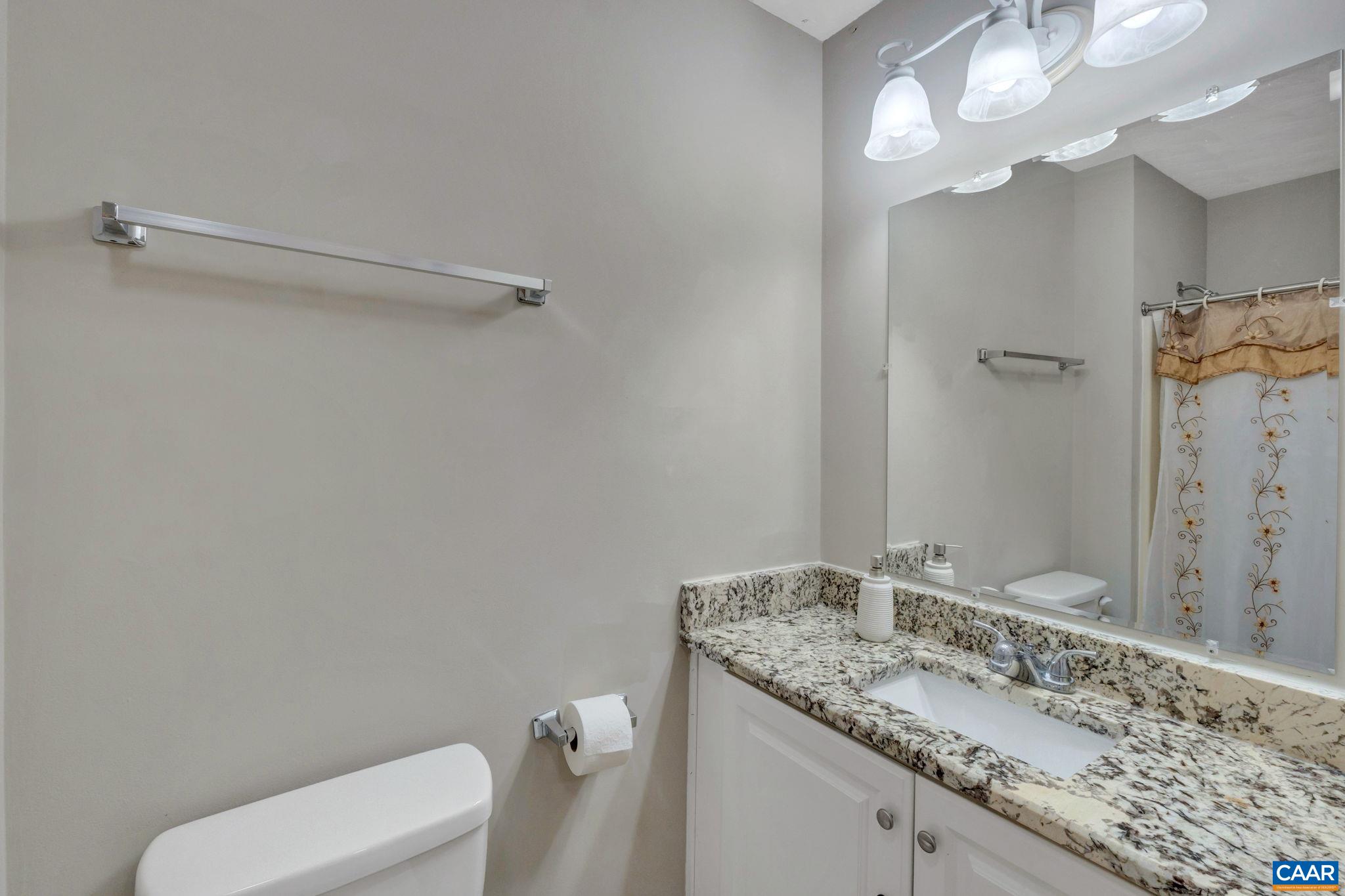 47 Dandelion Road Ruckersville, VA 22968 - Photo 17 of 35 a bathroom with a granite countertop sink mirror vanity and toilet