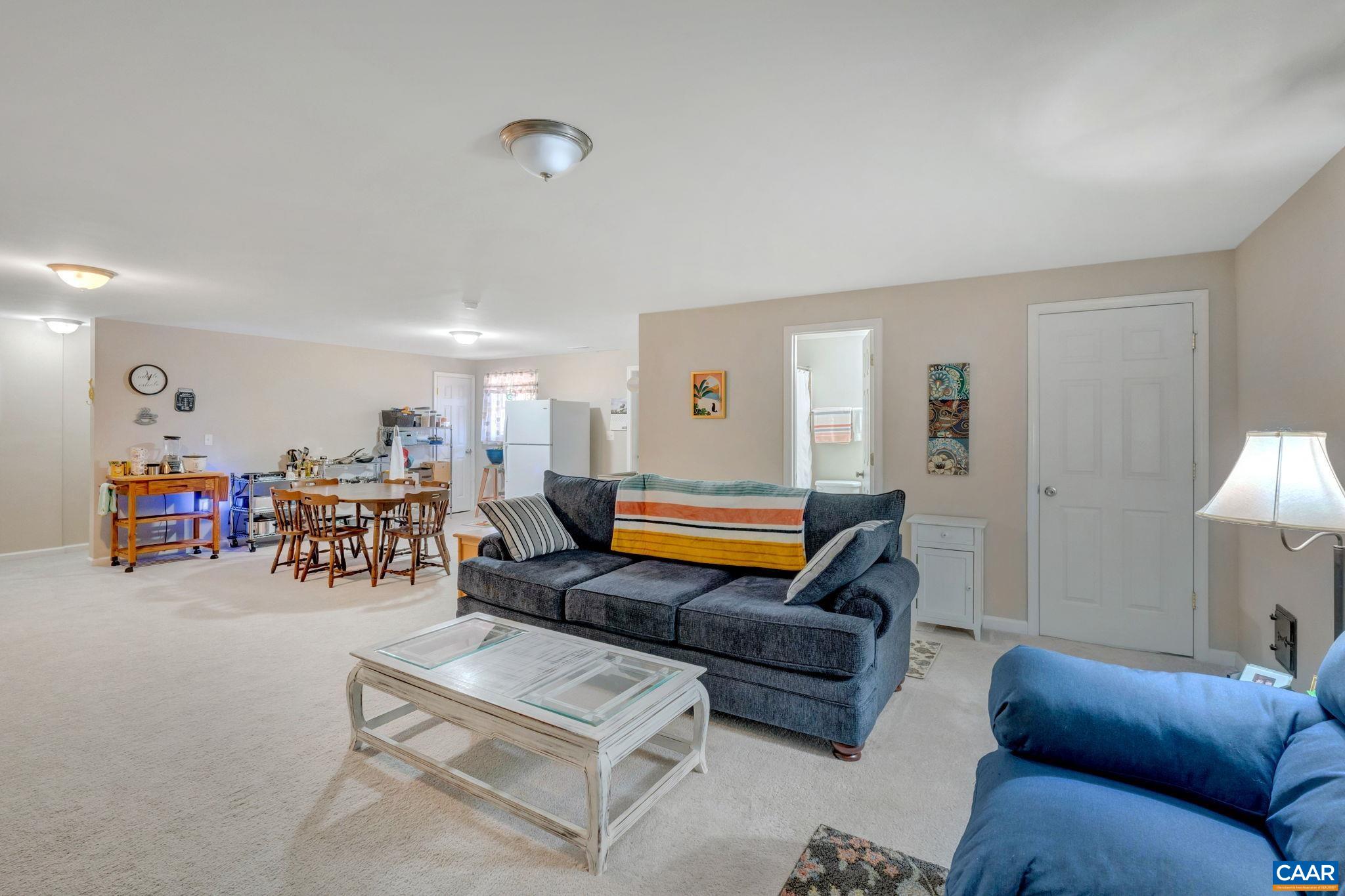 47 Dandelion Road Ruckersville, VA 22968 - Photo 18 of 35 a living room with furniture a table and a flat screen tv