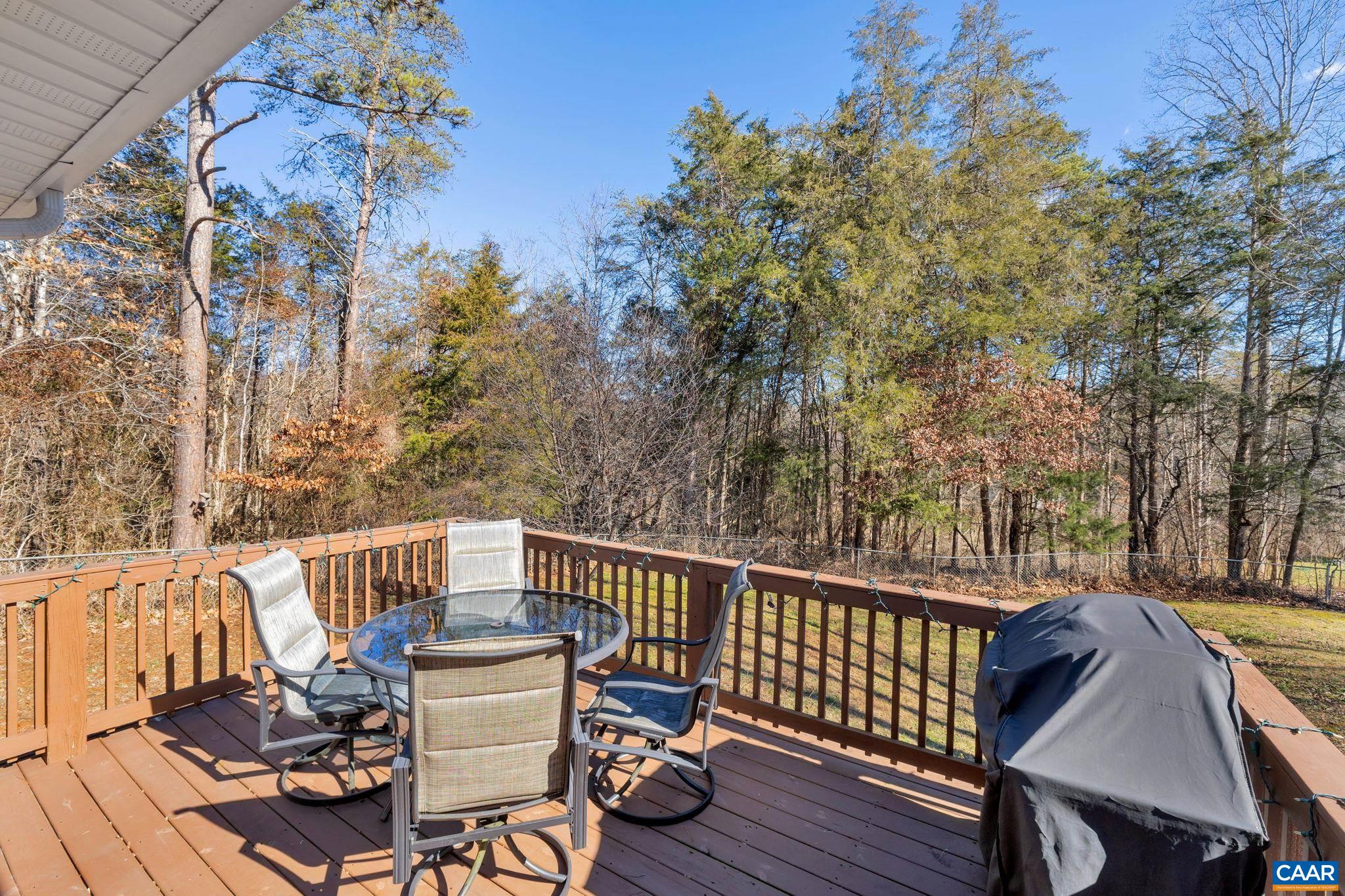 47 Dandelion Road Ruckersville, VA 22968 - Photo 26 of 35 a view of a deck with a table and chairs with wooden floor