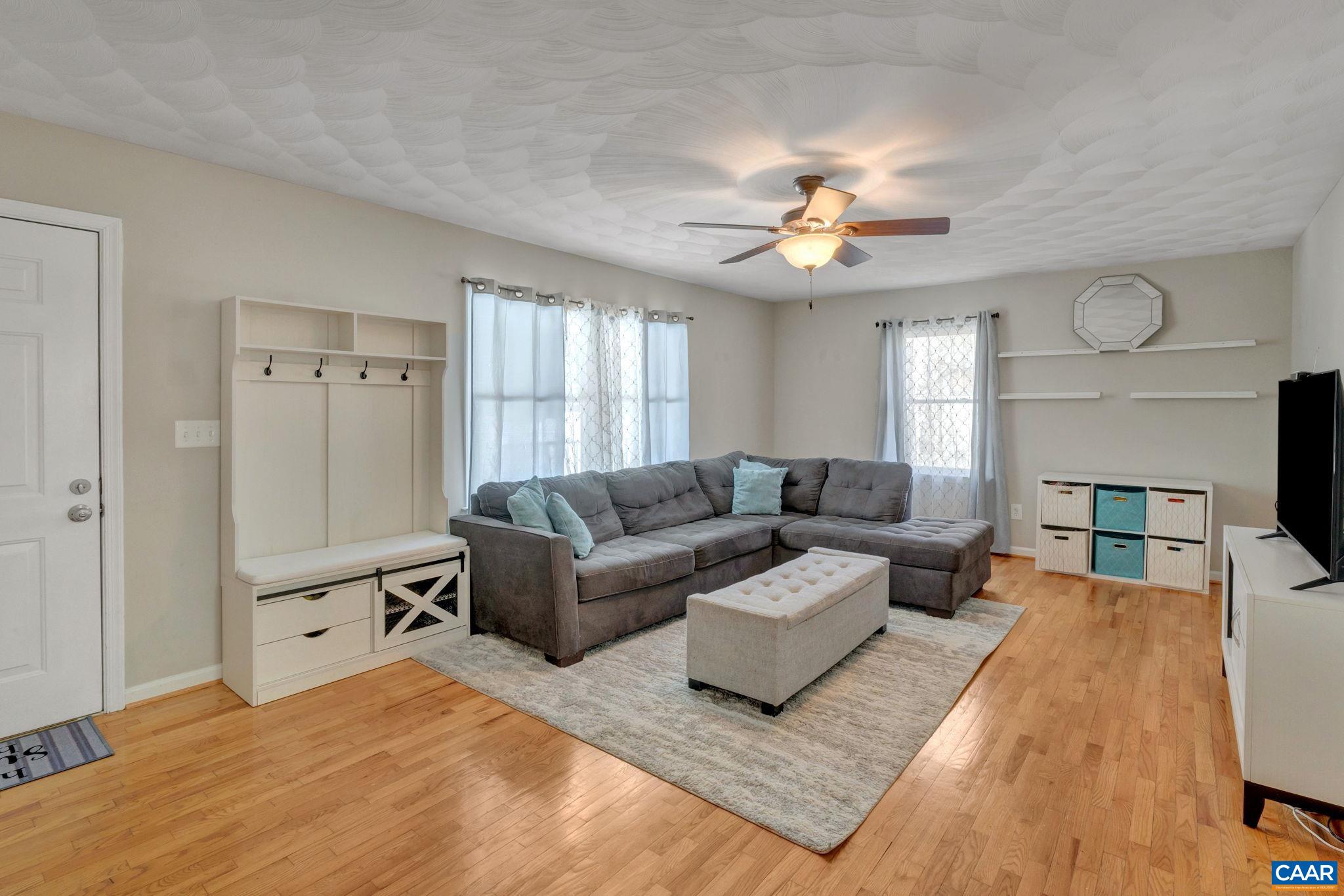 47 Dandelion Road Ruckersville, VA 22968 - Photo 6 of 35 a living room with furniture a fireplace and a ceiling fan