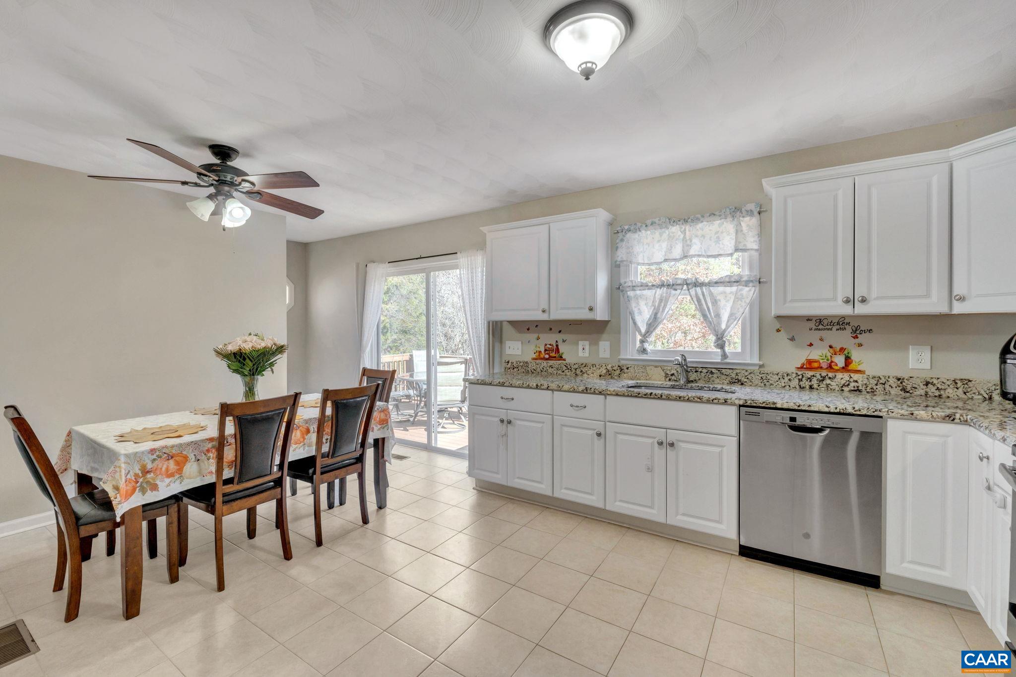 47 Dandelion Road Ruckersville, VA 22968 - Photo 9 of 35 a kitchen with granite countertop cabinets a dining table and chairs
