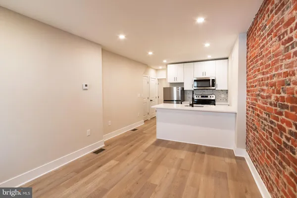 a kitchen with stainless steel appliances a refrigerator and a stove top oven