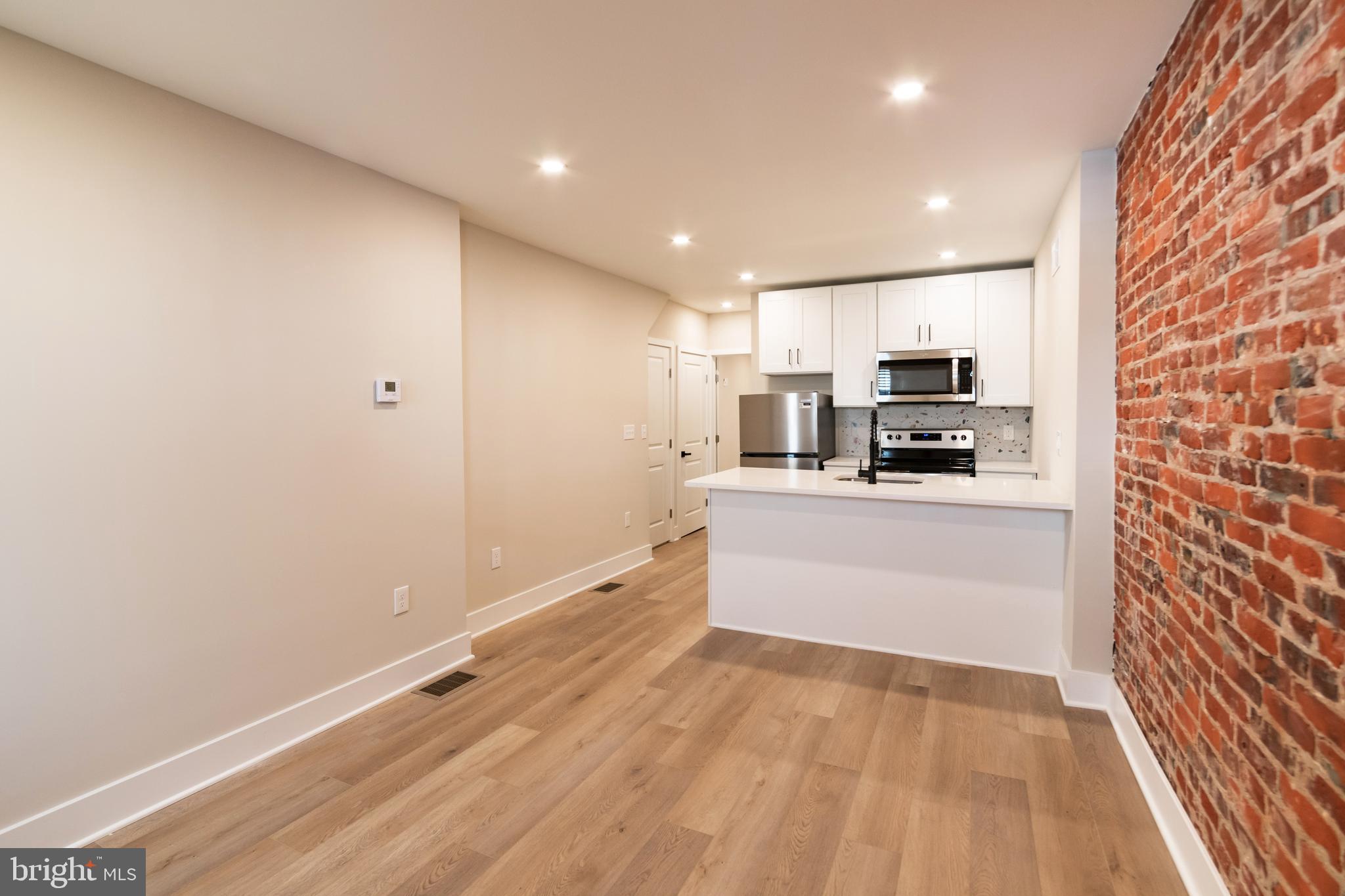 a kitchen with stainless steel appliances a refrigerator and a stove top oven